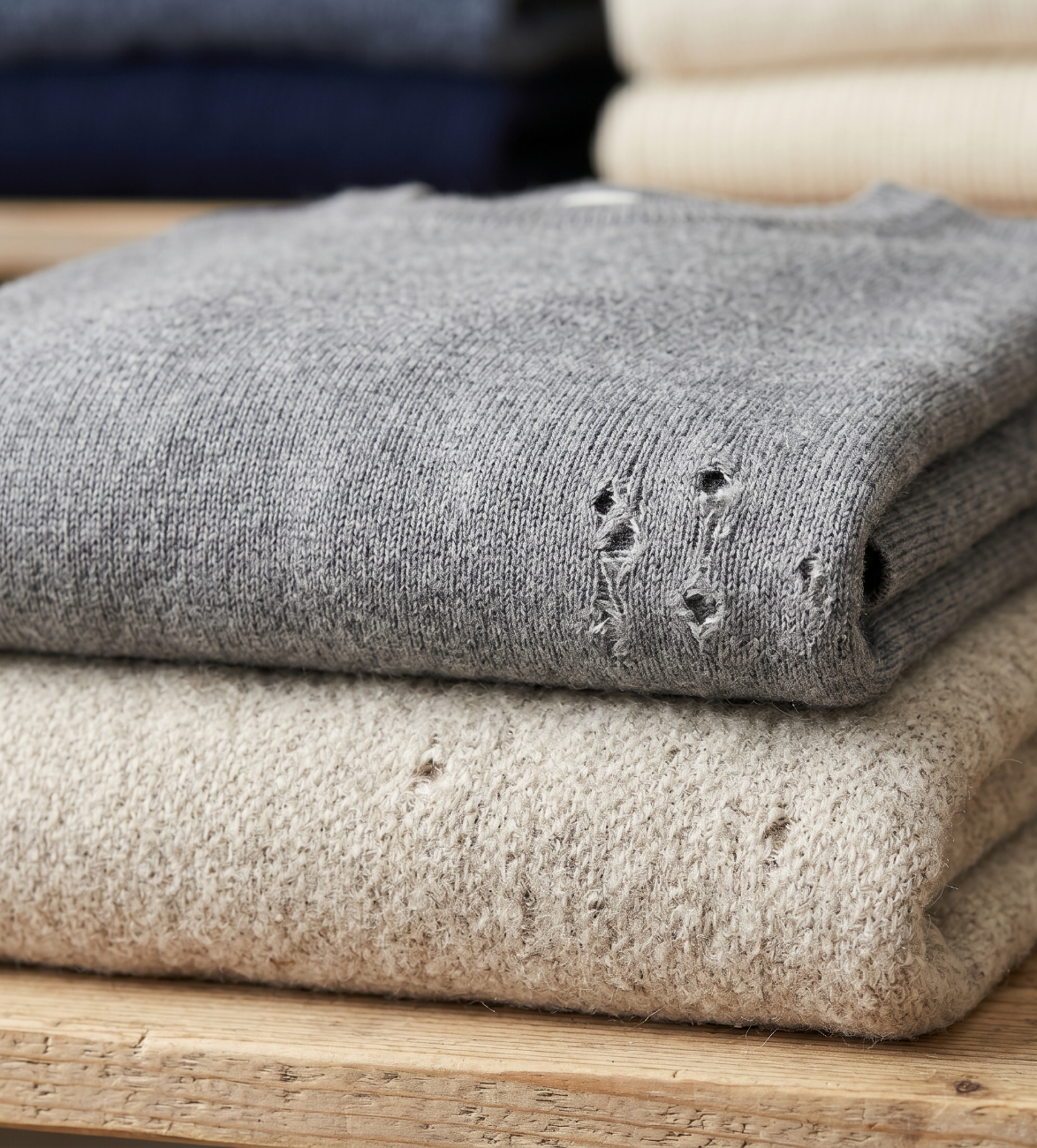 Small holes in natural fabric caused by moth larvae